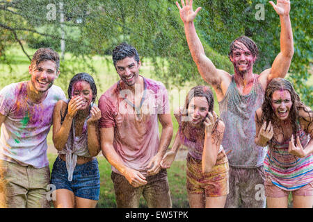 Happy friends covered in powder paint Stock Photo