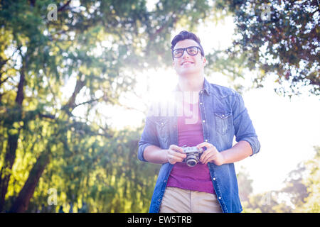 Handsome hipster holding vintage camera Stock Photo