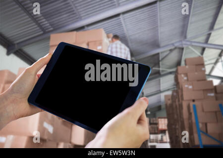 Composite image of hands holding tablet Stock Photo