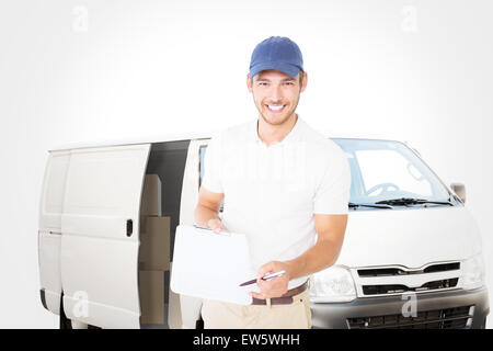 Composite image of happy delivery man holding clipboard Stock Photo