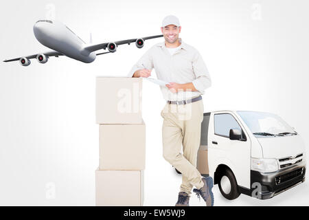 Composite image of delivery man with clipboard leaning on cardboard boxes Stock Photo