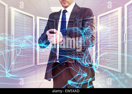 Composite image of focused businessman texting on his mobile phone Stock Photo