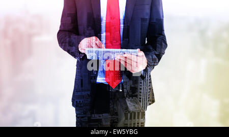 Composite image of businessman scrolling on his digital tablet Stock Photo