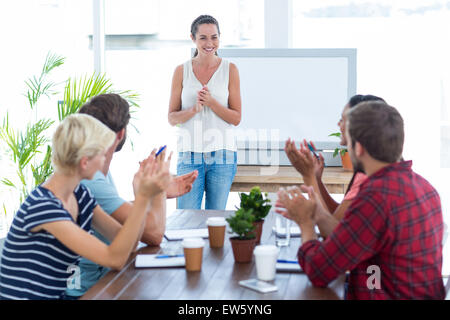 Colleagues clapping hands in a meeting Stock Photo