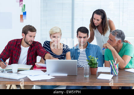 Creative business team using laptop in meeting Stock Photo