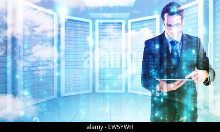 Composite image of businessman standing while using a tablet pc Stock Photo