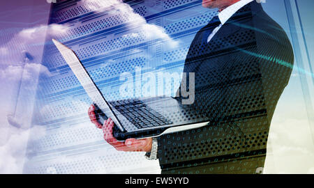 Composite image of businessman with watch using tablet pc Stock Photo