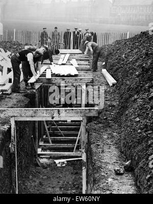 Timbering up the deep trenches in Birkenhead Park. The shelters will have seats along each side and be covered with loose earth.  Birkenhead, Merseyside, 28th September 1938. Stock Photo