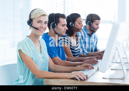 Smiling young call centre worker Stock Photo
