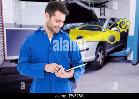 Composite image of male mechanic using digital tablet