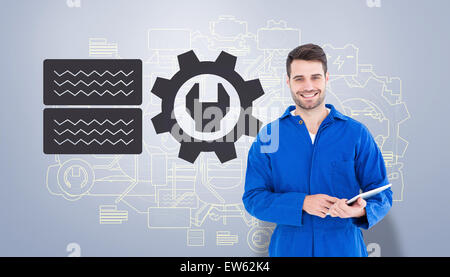 Composite image of happy young male mechanic using digital tablet Stock Photo