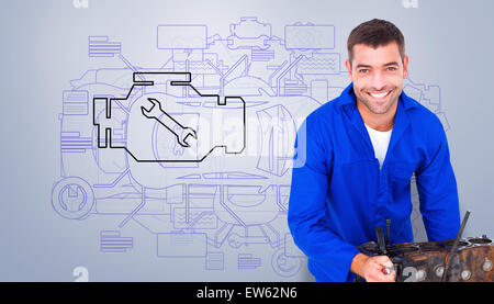 Composite image of smiling male machanic repairing car engine Stock Photo