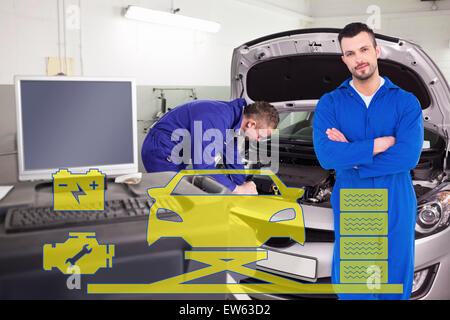 Composite image of mechanic standing arms crossed on white background Stock Photo