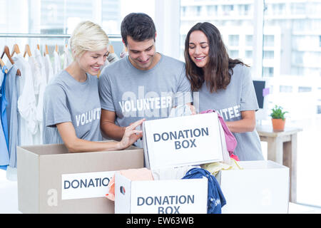 Volunteers friends checking a donation list Stock Photo