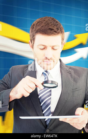 Composite image of businessman looking at tablet with magnifying glass