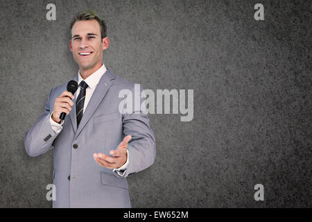 Composite image of businessman giving speech Stock Photo