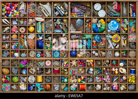 Wooden tray of childrens toys and a treasure trove of small collectable items Stock Photo