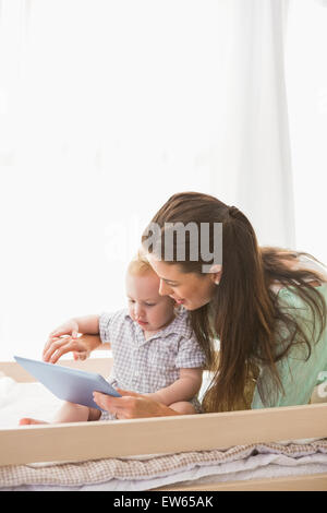 Happy mother using tablet with his baby boy Stock Photo