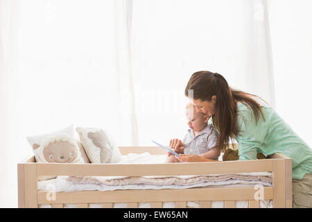 Happy mother using tablet with his baby boy Stock Photo