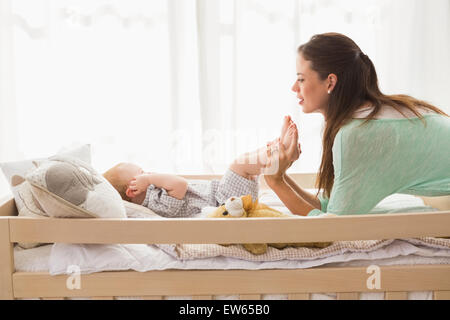 Happy mother using laptop with her baby boy Stock Photo