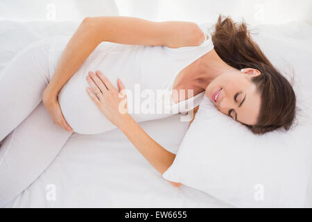 Happy pregnancy is lengthened on his bed Stock Photo