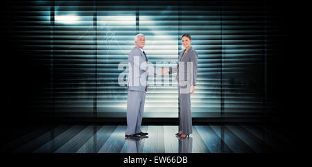 Composite image of business team shaking hands Stock Photo