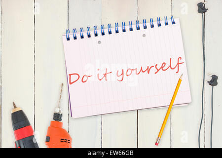 Do it yourself against tools and tablet on wooden background Stock Photo