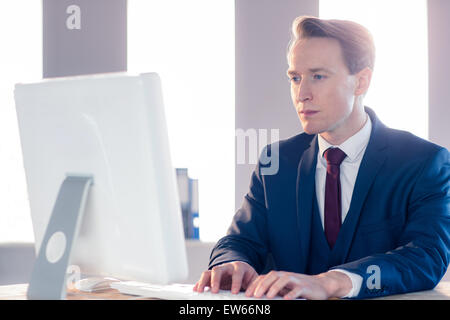 Serious businessman typing on computer Stock Photo