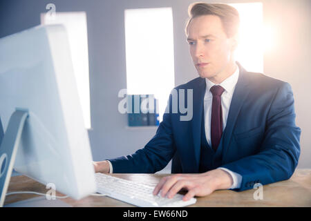 Serious businessman typing on computer Stock Photo