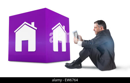 Composite image of mature businessman sitting using tablet Stock Photo