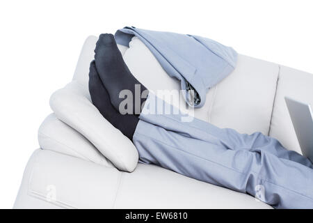 Businessman lying on couch legs only visible Stock Photo