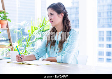 Woman taking notes during a meeting Stock Photo