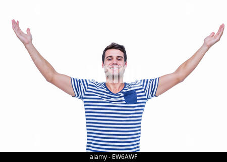 Handsome hipster smiling at camera with arms outstretched Stock Photo