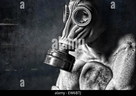 sad man sitting in corner and hugging knees on textured background in ...