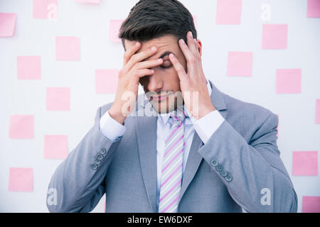 Businessman having headache in office Stock Photo