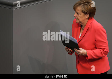 Berlin. 18th June, 2015. German Chancellor Angela Merkel leaves after addressing a session of the German lower house of parliament Bundestag in Berlin on June 18, 2015. German Chancellor Angela Merkel reiterated on Thursday that her government wanted to keep Greece in the euro zone, but the indebted country must stick to its promised structural reforms in order to reach a deal with international creditors. © Zhang Fan/Xinhua/Alamy Live News Stock Photo