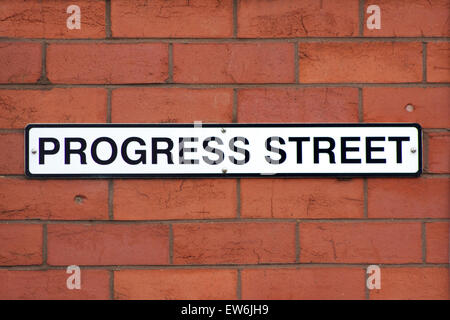 "progress" street sign on red brick wall Stock Photo