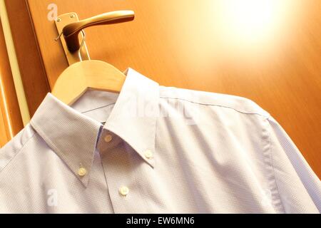 Handle, holds a wooden hanger with a man's shirt Stock Photo