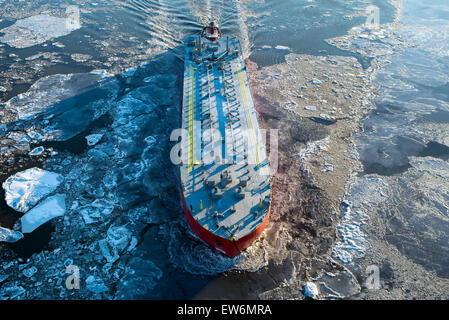 A large ship sails up a frozen river Stock Photo
