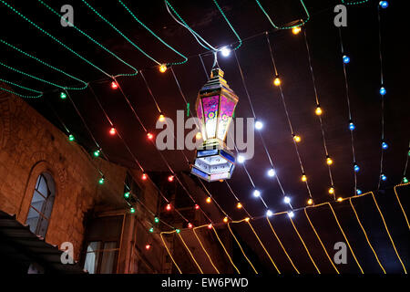 Festive lights and fanous Ramadan decorations in an alley in the Muslim Quarter during the Muslim holy month of Ramadan in the Old City of Jerusalem Israel Stock Photo