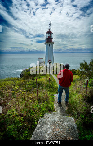 Man viewing Sheringham Point Lighthouse- Shirley, British Columbia, Canada.-Note-Jacket color digitally changed. Stock Photo