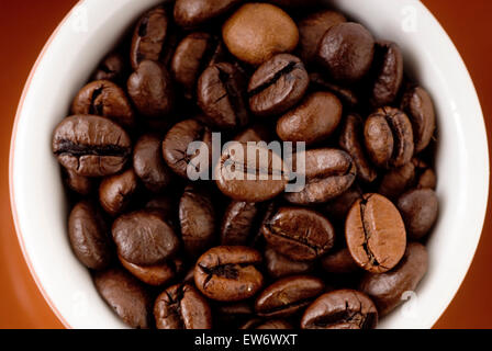 Espresso cup filled with coffee beans Stock Photo