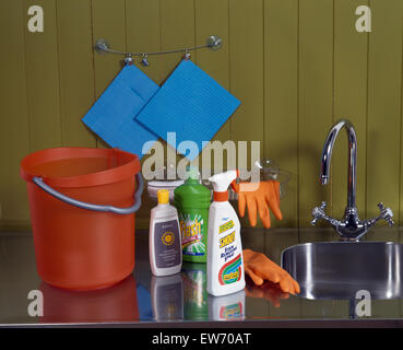Blue bucket with cleaning products and rubber gloves for homework on a ...