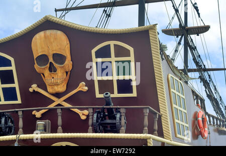 The photo shows a fragment of the stern of a yacht, with the image of a pirate symbols: skulls, crossbones, models of guns. Stock Photo