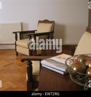 Edwardian style cane sided chairs in traditional living room Stock Photo