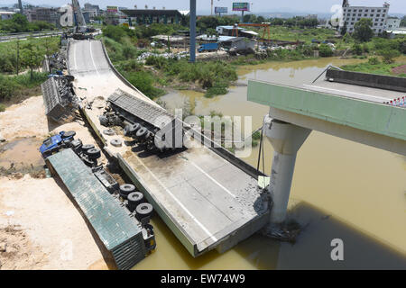 Heyuan, China's Guangdong Province. 19th June, 2015. Heavy trucks fall under a highway after a ramp of the Guangdong-Jiangxi Highway collapses in Heyuan, south China's Guangdong Province, June 19, 2015. The accident, which killed one person and injured four others, happened at 3:40 a.m. on June 19 (1940 GMT on June 18) in Heyuan City when a bridge ruptured with four heavy trucks loaded with porcelain clay on it, according to an investigation. The highway, opened to traffic in December of 2005, connects Guangdong with east China's Jiangxi Province. Credit:  Lu Hanxin/Xinhua/Alamy Live News Stock Photo