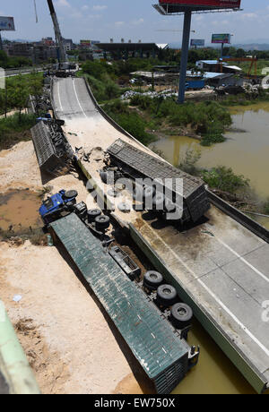 Heyuan, China's Guangdong Province. 19th June, 2015. Heavy trucks fall under a highway after a ramp of the Guangdong-Jiangxi Highway collapses in Heyuan, south China's Guangdong Province, June 19, 2015. The accident, which killed one person and injured four others, happened at 3:40 a.m. on June 19 (1940 GMT on June 18) in Heyuan City when a bridge ruptured with four heavy trucks loaded with porcelain clay on it, according to an investigation. The highway, opened to traffic in December of 2005, connects Guangdong with east China's Jiangxi Province. Credit:  Lu Hanxin/Xinhua/Alamy Live News Stock Photo