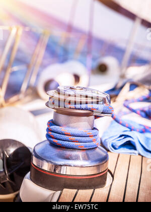 Closeup photo of detail of sailboat, yacht winch with rope on it, traveling along sea on water transport, active lifestyle Stock Photo
