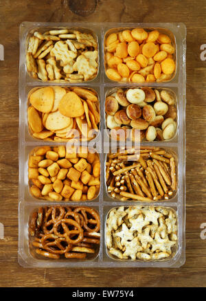 Various salty snacks - crackers, chips, nuts, pretzels Stock Photo