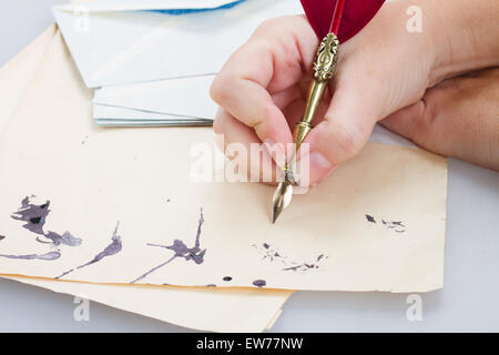 hand holding feather pen Stock Photo